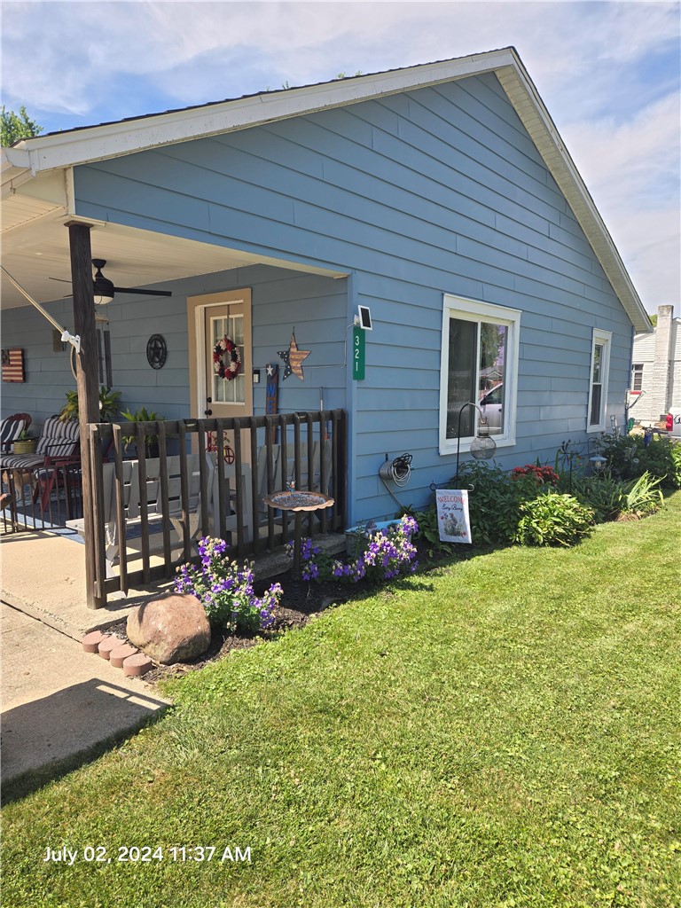 321 Liberty Street Eaton, OH 45320 - Photo 19 of 34 This charming home offers a welcoming front porch with lovely landscaping and a manicured lawn.