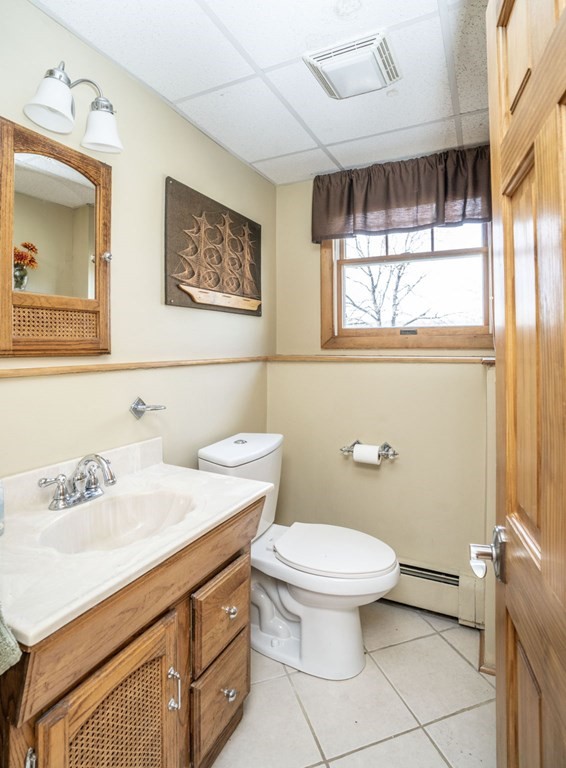 56 Spring Street Plainville, MA 02762 - Photo 18 of 21 a bathroom with a sink a mirror and a toilet