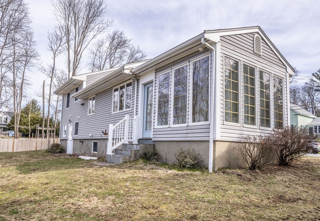 56 Spring Street Plainville, MA 02762 - Photo 4 of 21 a front view of a house with a garden
