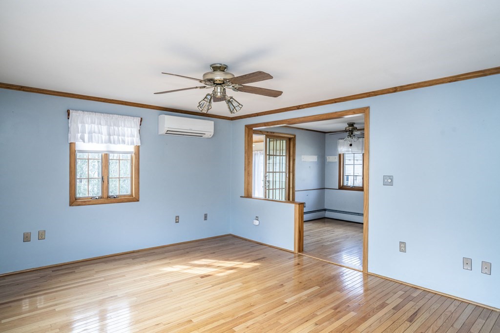 56 Spring Street Plainville, MA 02762 - Photo 6 of 21 a view of empty room with wooden floor and fan