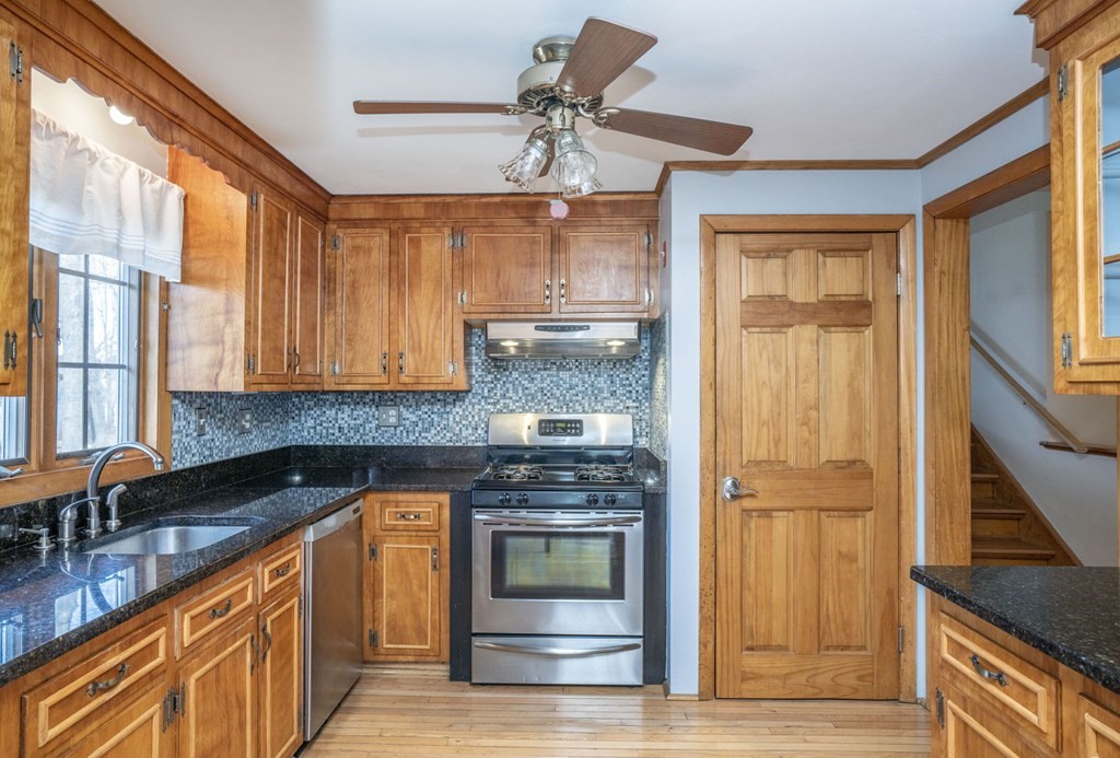 56 Spring Street Plainville, MA 02762 - Photo 7 of 21 a kitchen with stainless steel appliances granite countertop a stove a sink and a refrigerator