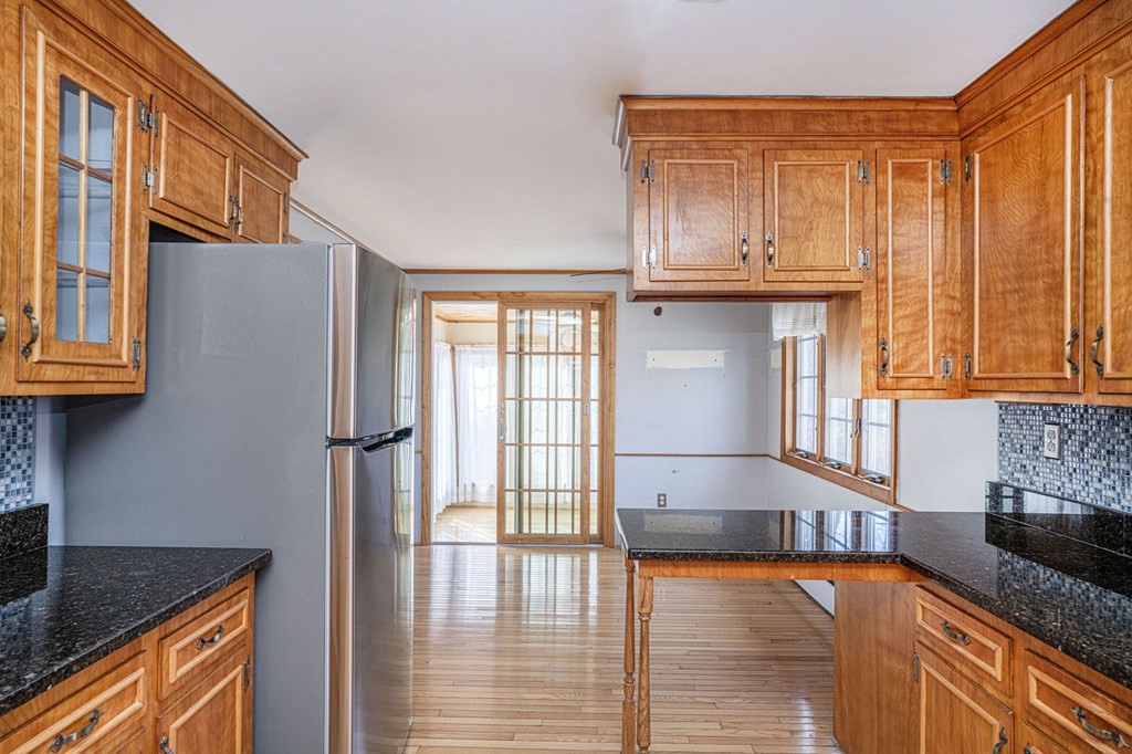 56 Spring Street Plainville, MA 02762 - Photo 9 of 21 a kitchen with stainless steel appliances granite countertop a refrigerator and a stove top oven