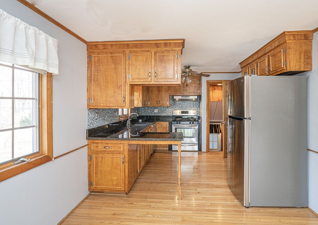 56 Spring Street Plainville, MA 02762 - Photo 10 of 21 a kitchen with stainless steel appliances granite countertop a refrigerator a stove and a sink