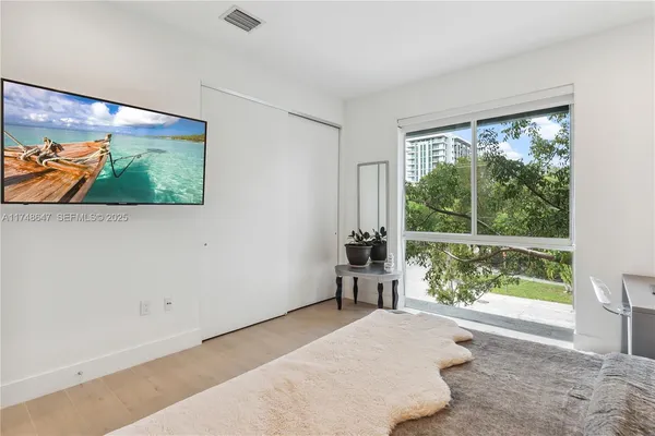a bedroom with a bed and glass window
