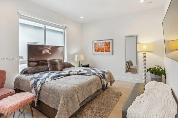 a bedroom with bed and window