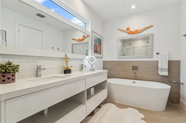 a bathroom with a bathtub a sink and a window