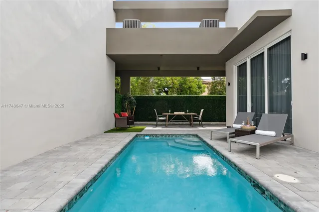 a view of swimming pool with lounge chair and couch