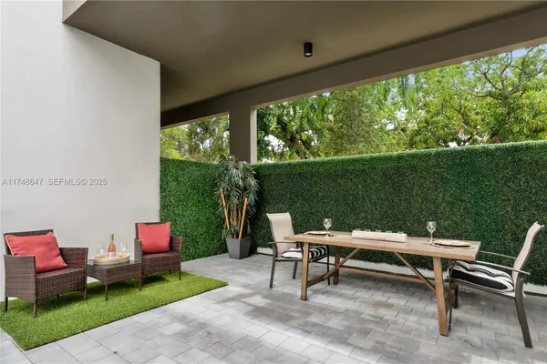 a backyard of a house with outdoor seating