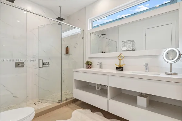 a bathroom with a tub sink mirror and shower