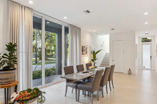 a dining room with furniture and wooden floor