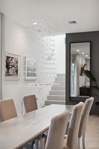 a view of a dining room with furniture and a large window