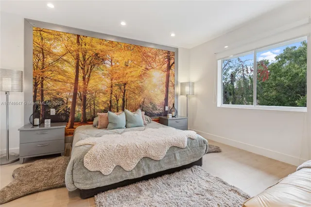 a bedroom with a large bed and a large window