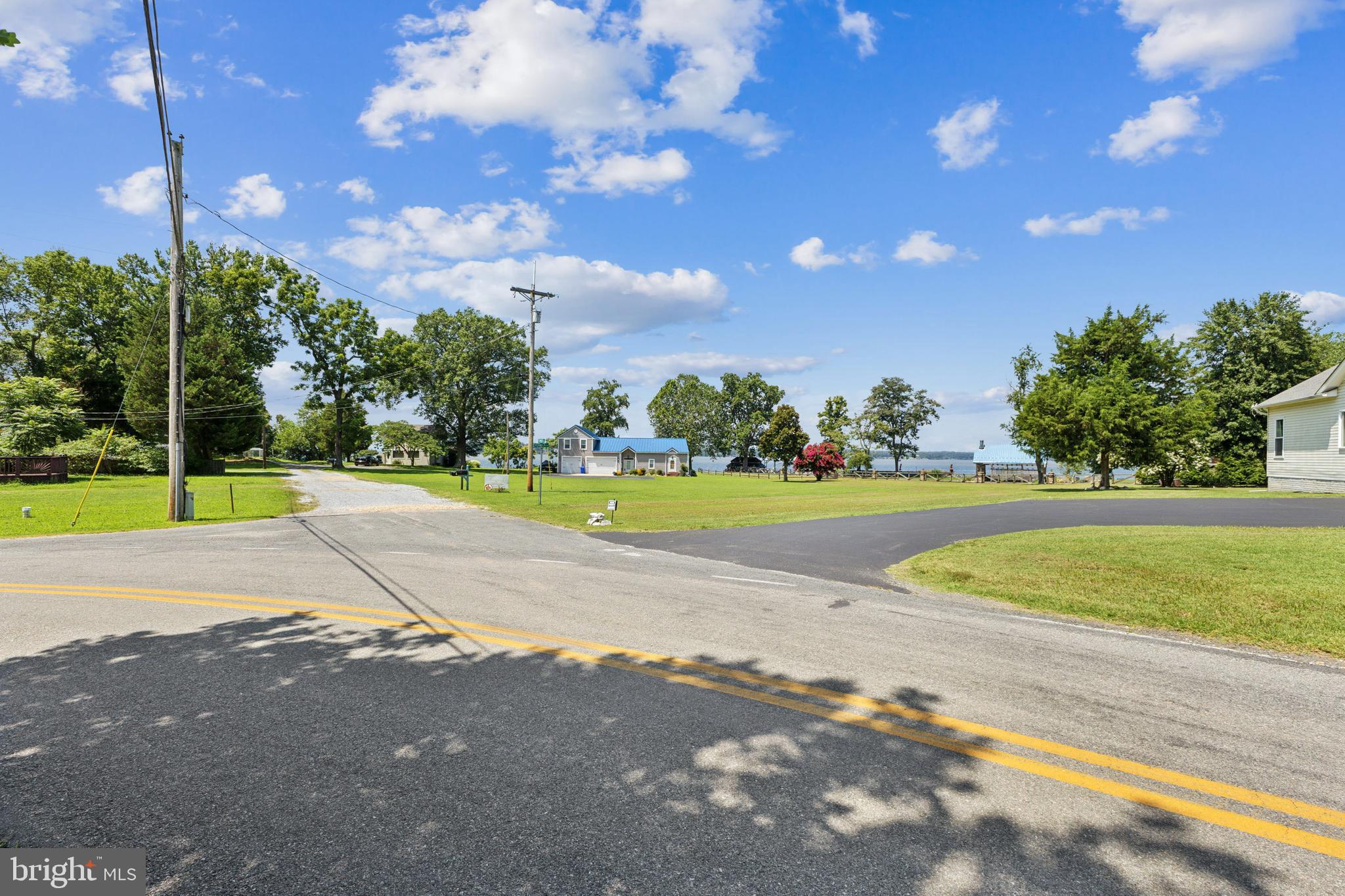 6005 Fenwick Road Bryans Road, MD 20616 - Photo 4 of 9 a view of a house with a big yard and palm trees