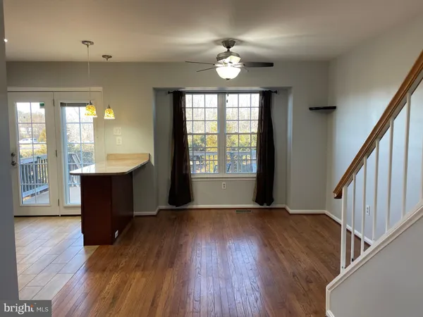 a view of a room with wooden floor and fan