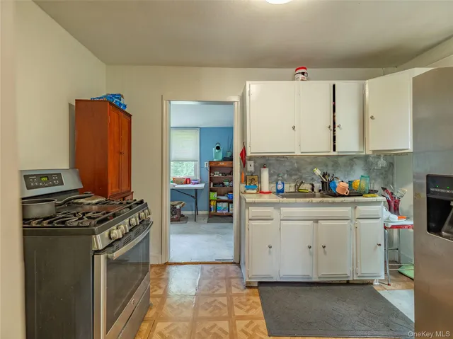 a kitchen with stainless steel appliances granite countertop a stove and a sink