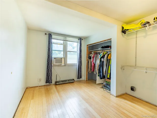 a view of a room with wooden floor and a window