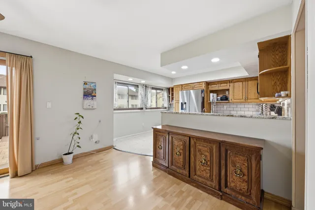 a open kitchen with a sink and dishwasher with wooden floor