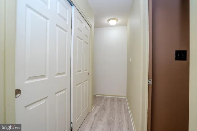 a view of a hallway with wooden floor