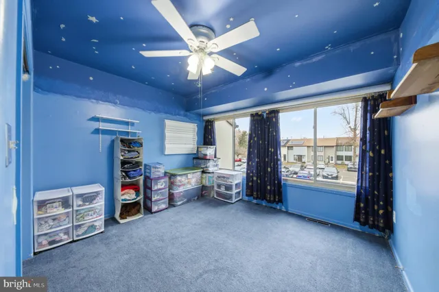 a view of a livingroom with furniture and a large window