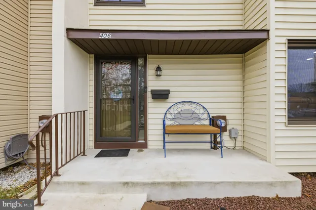 a front view of a house with a bench