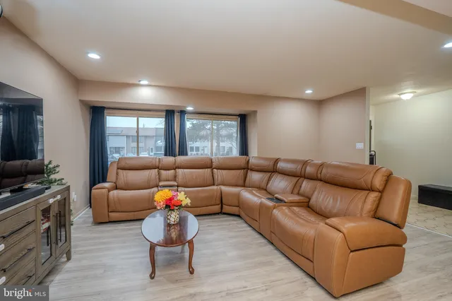a living room with furniture window and a flat screen tv