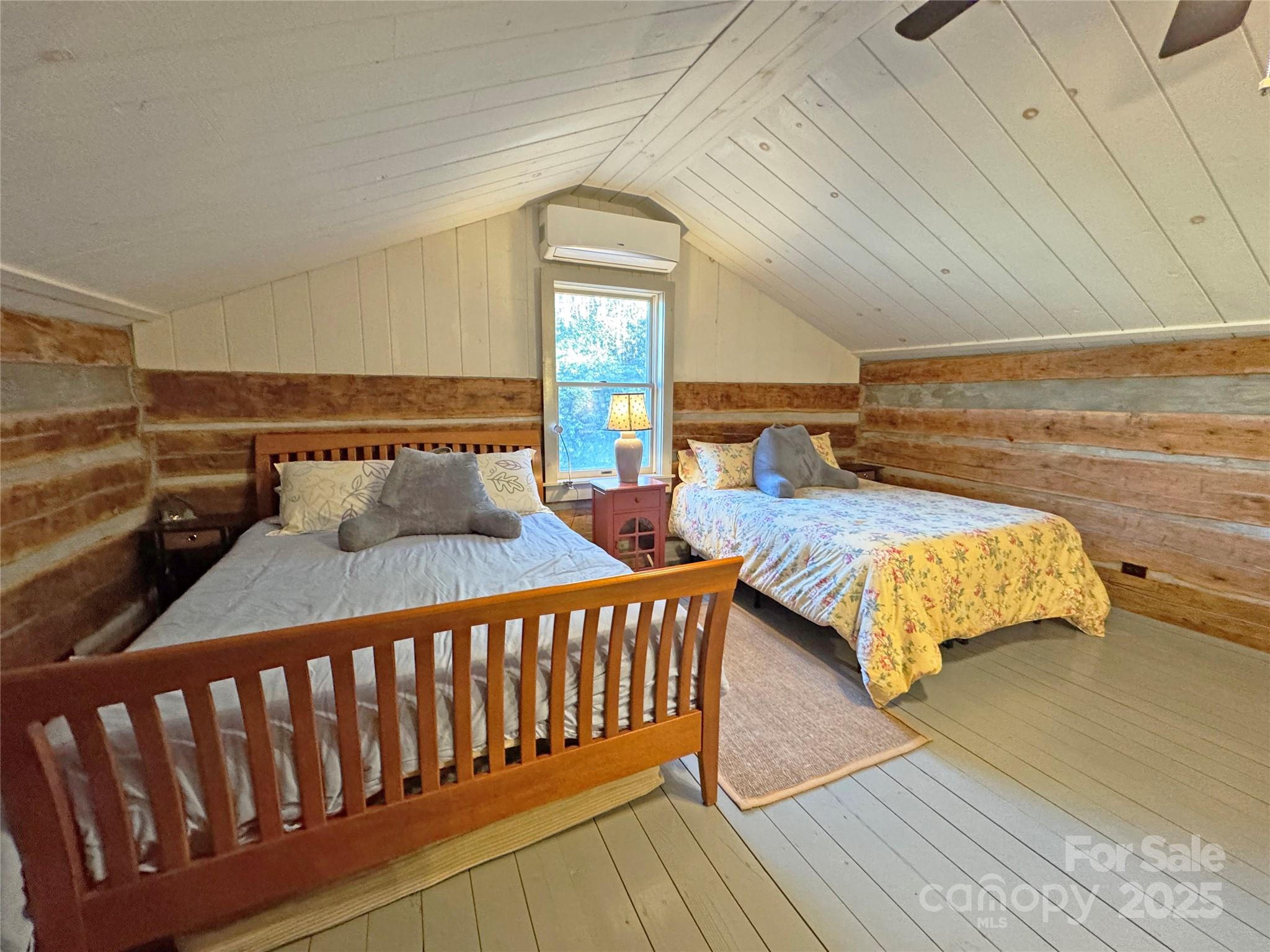 3076 Anderson Cove Road Hot Springs, NC 28743 - Photo 25 of 44 a bedroom with two beds and wooden floor