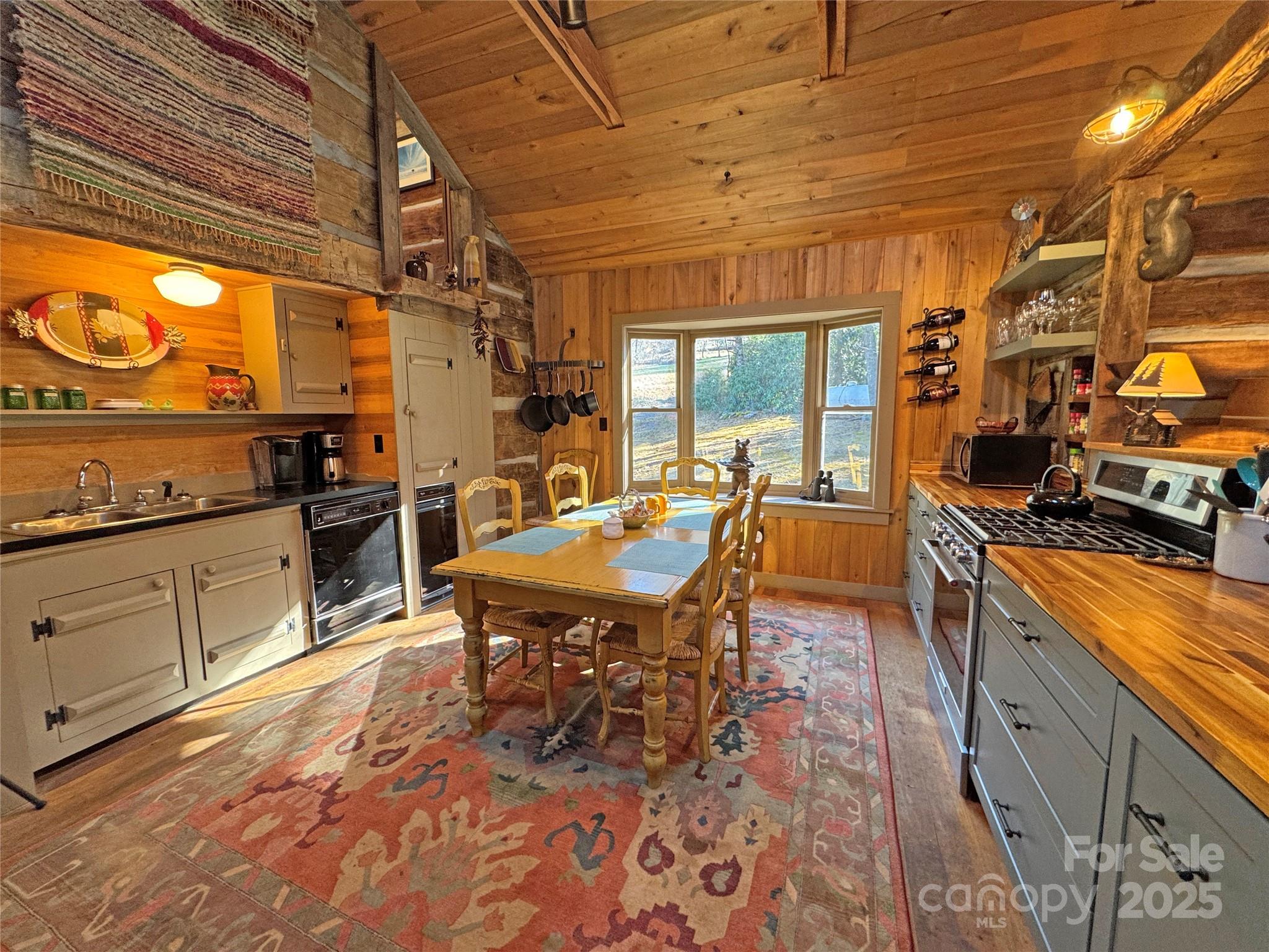 3076 Anderson Cove Road Hot Springs, NC 28743 - Photo 9 of 44 a open kitchen with stainless steel appliances granite countertop a stove a sink dishwasher and cabinets with wooden floor
