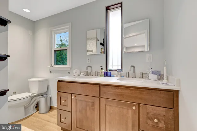 a bathroom with a toilet sink and mirror