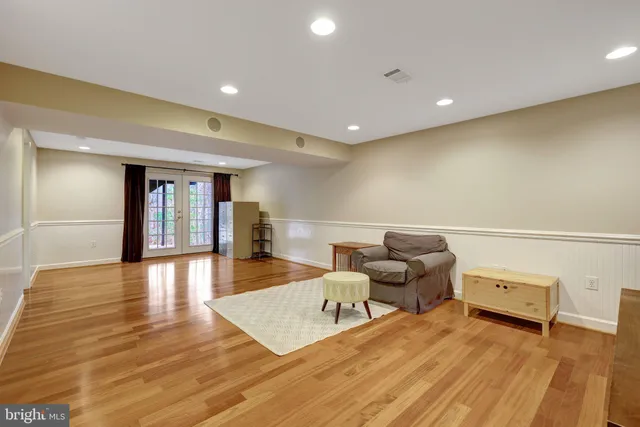 a living room with couch and a wooden floor