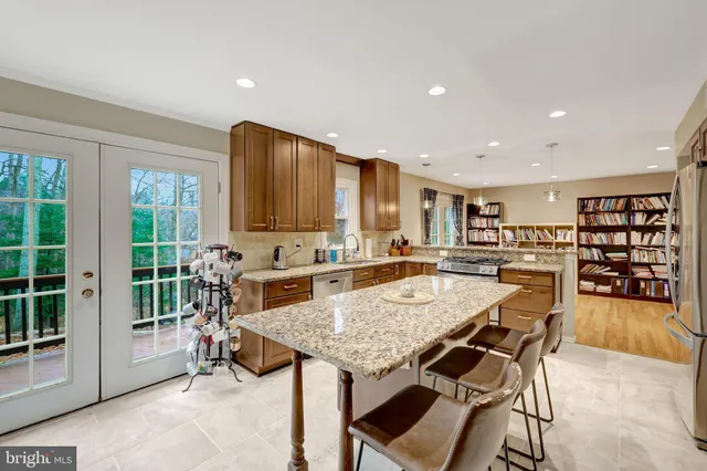 a view of a kitchen with a dining table and chairs