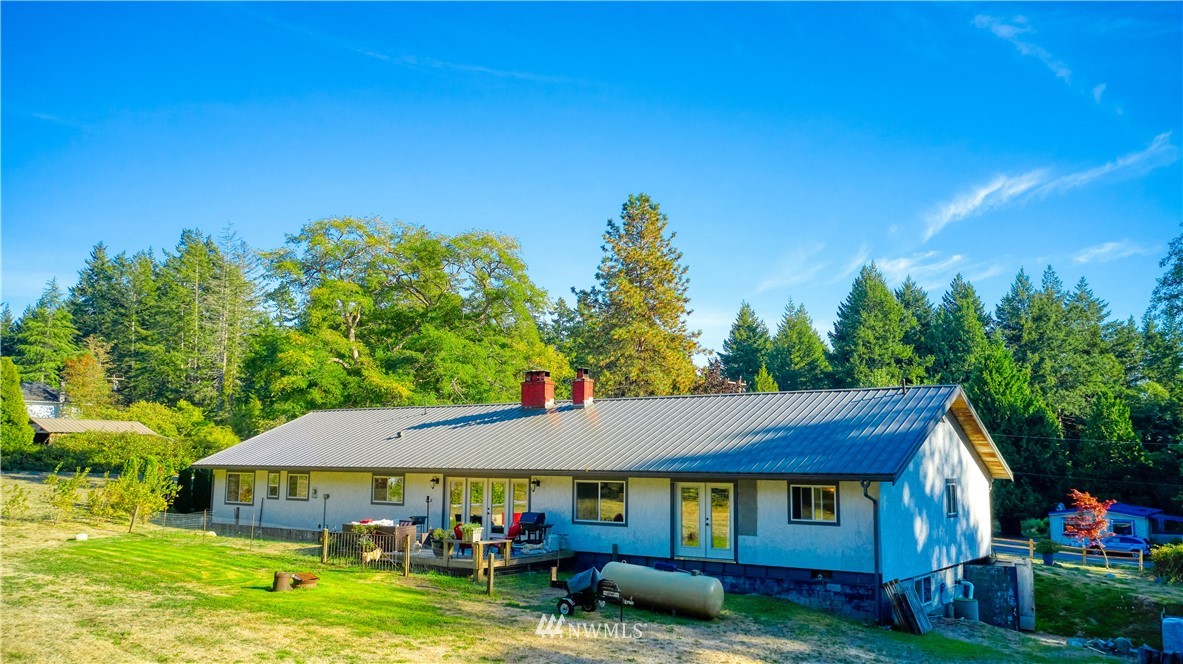 1890 Benson Road Point Roberts, WA 98281 - Photo 4 of 35 a view of a house with garden and a patio