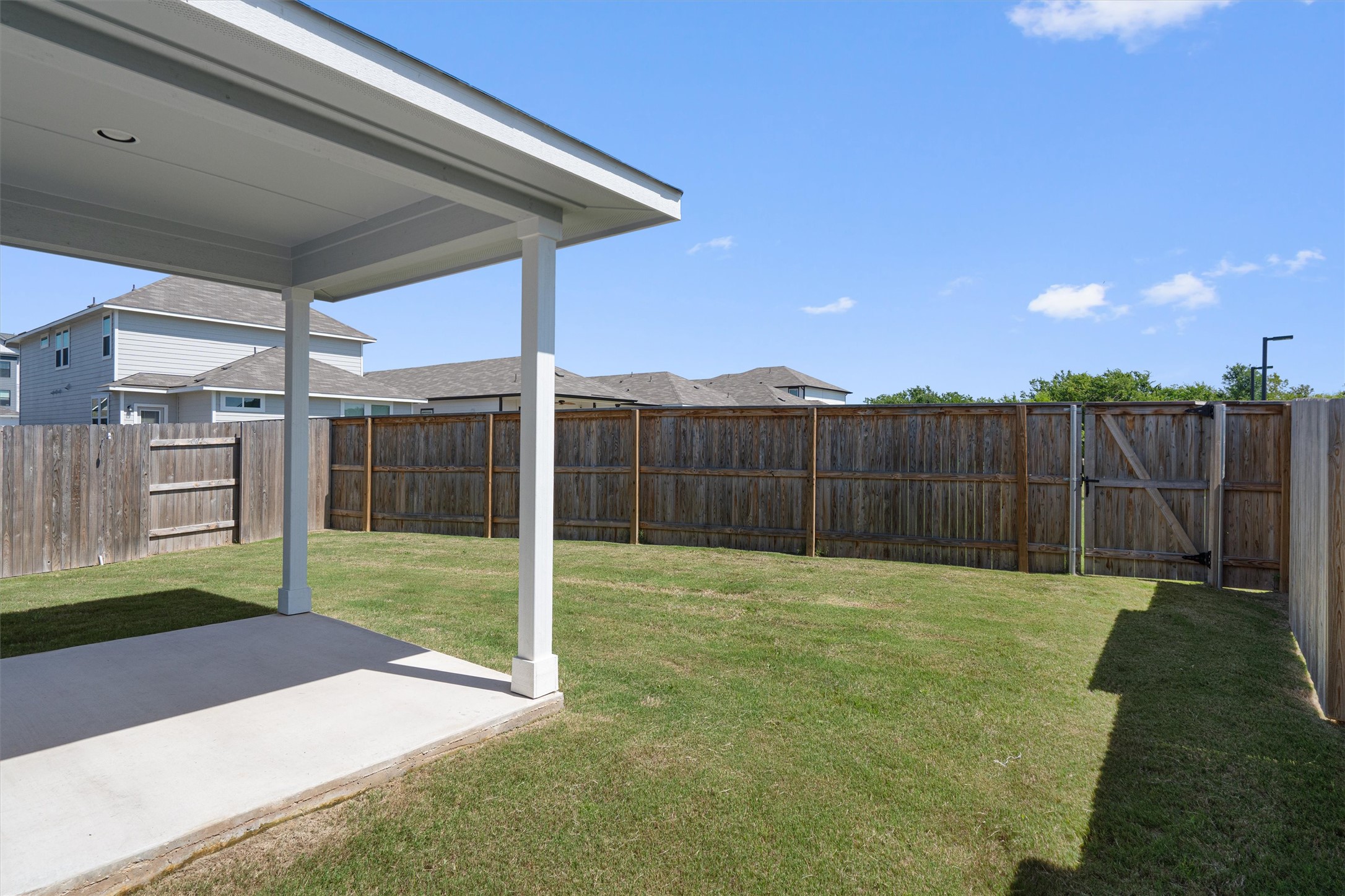 2606 Totley Road Manor, TX 78653 - Photo 20 of 28 a view of a backyard with wooden fence