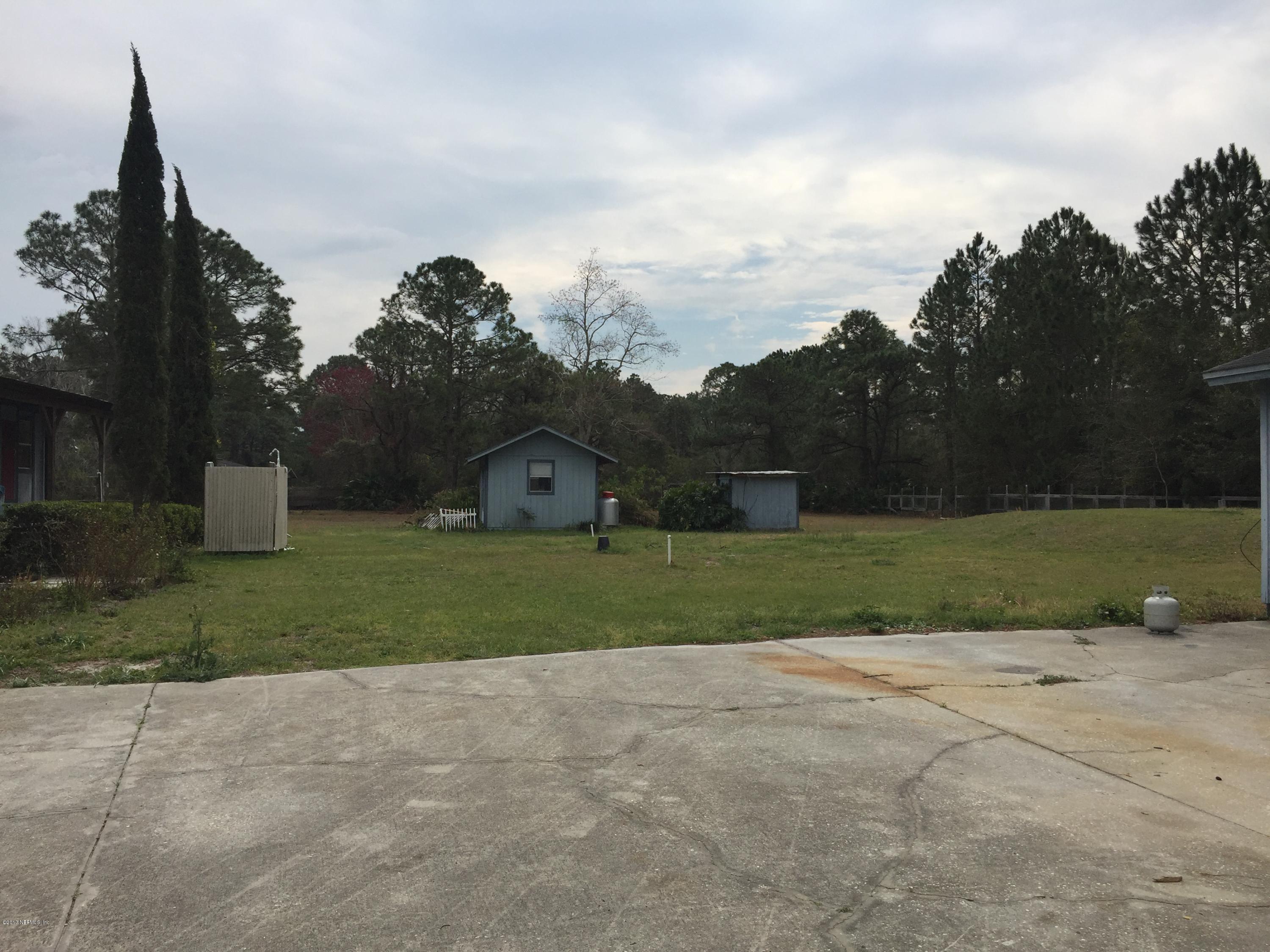 10400 Sawpit Road Jacksonville, FL 32226 - Photo 23 of 30 front view of a house with a yard and a garden