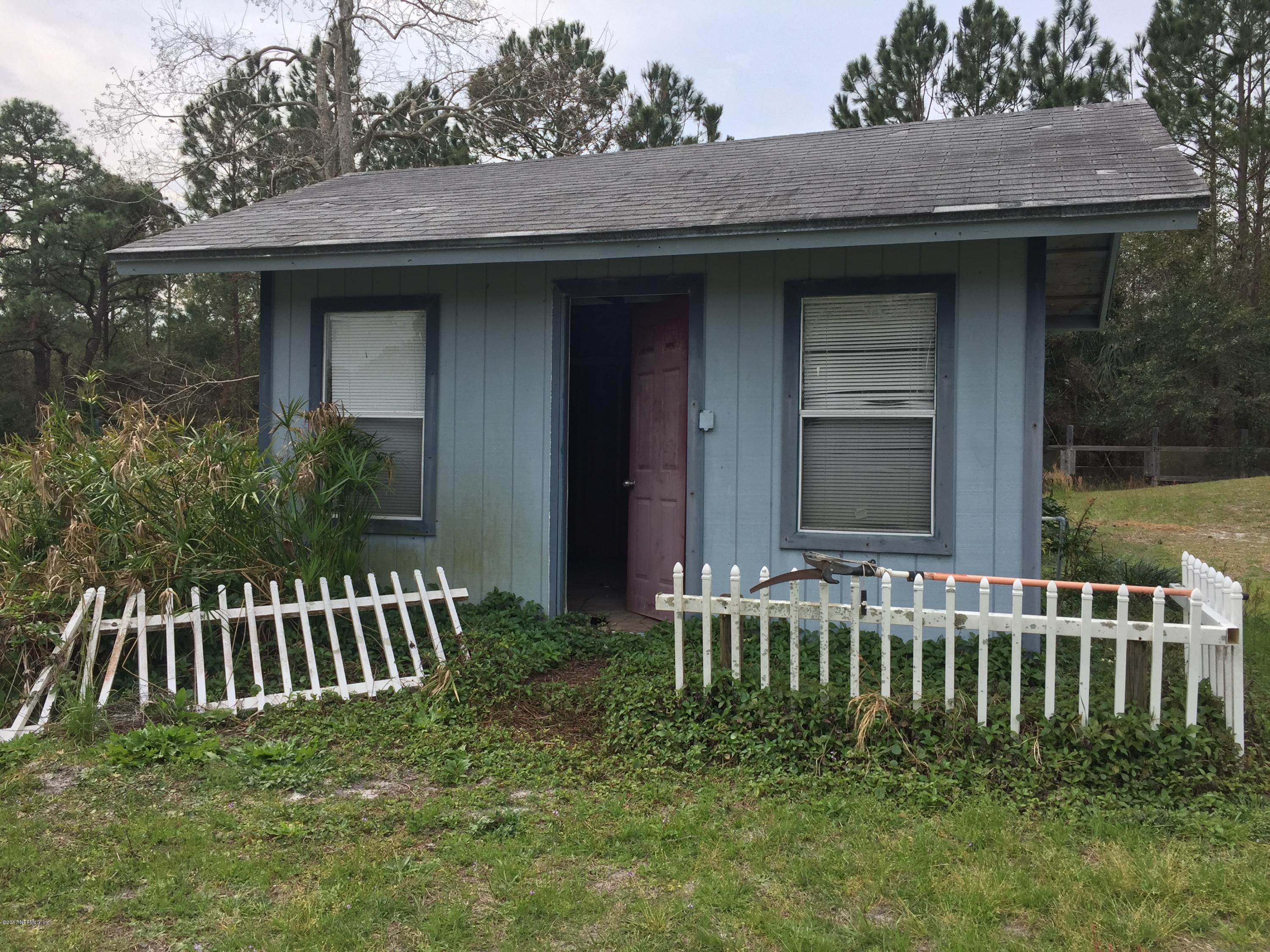 10400 Sawpit Road Jacksonville, FL 32226 - Photo 29 of 30 a wooden bench sitting in front of a house