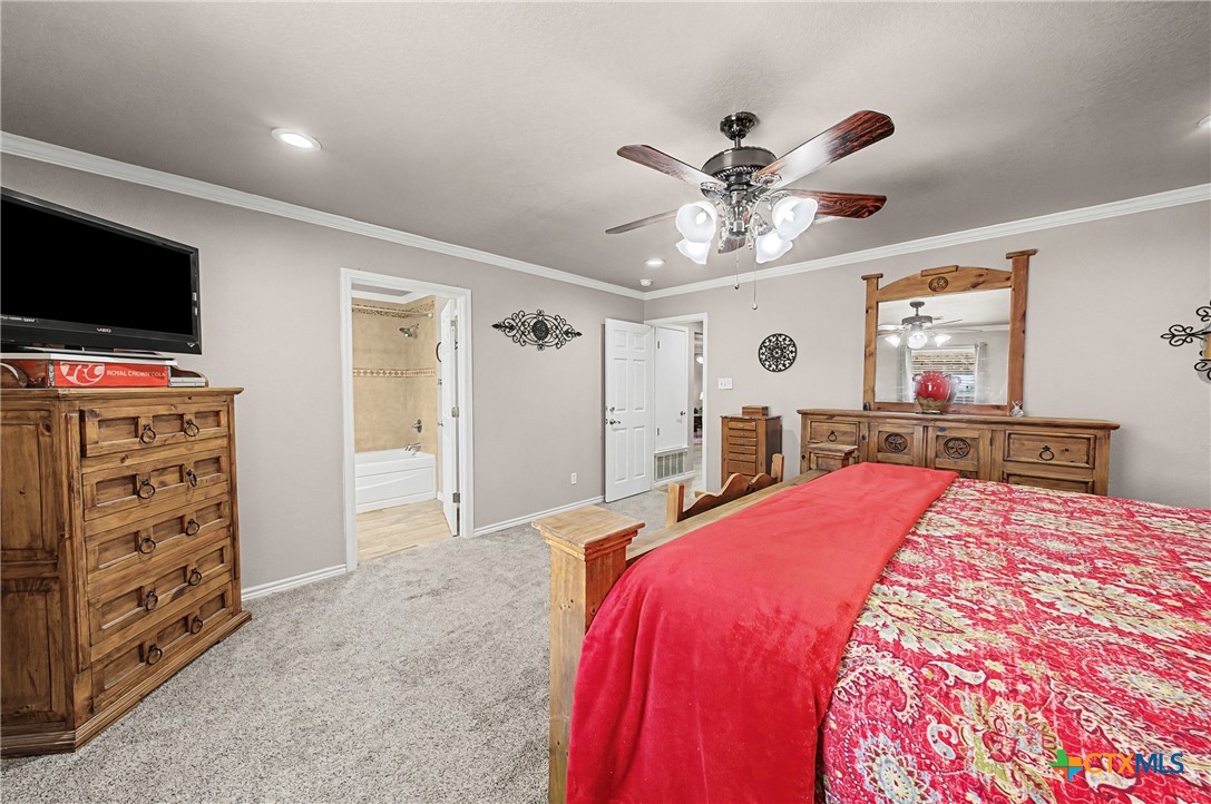 1601 Sunset Circle Cameron, TX 76520 - Photo 28 of 40 a bedroom with a bed and a flat screen tv
