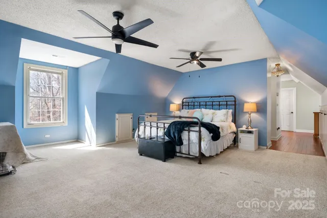 a bedroom with a bed and a ceiling fan