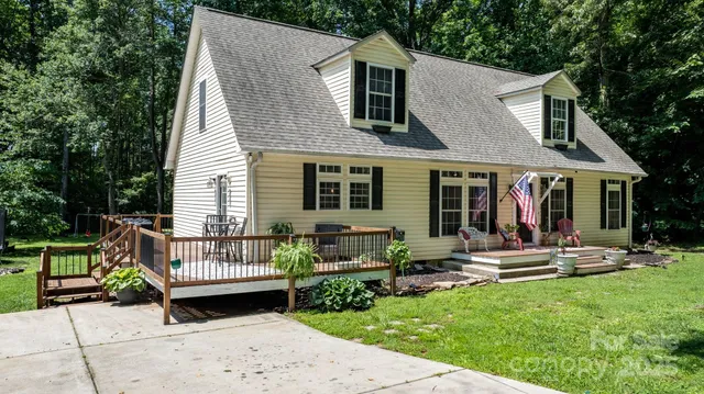 a front view of a house with a yard table and chairs