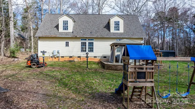 a view of a house with a yard and furniture