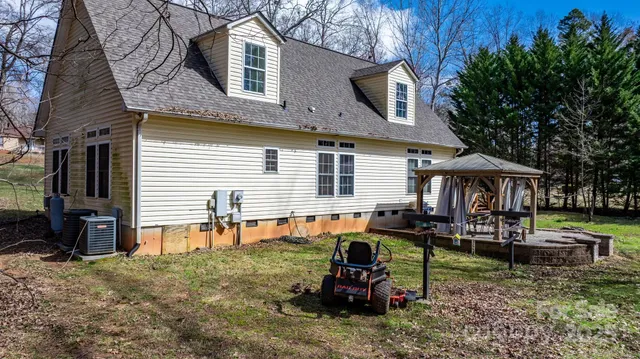 a view of a house with a yard and a tree