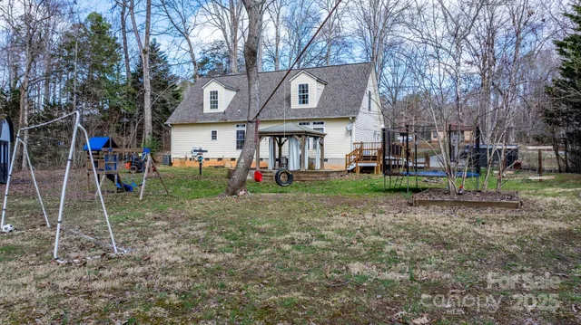 a view of a house with backyard and sitting area