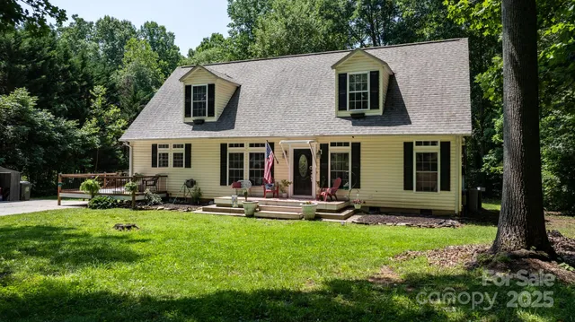 a view of a house with a yard and sitting area