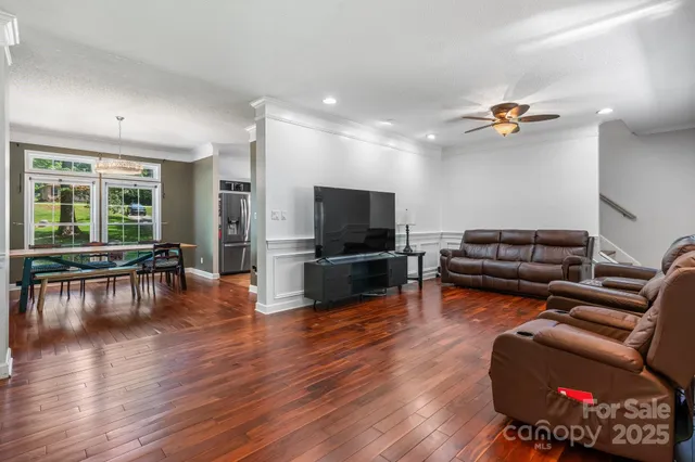 a living room with furniture fireplace and flat screen tv