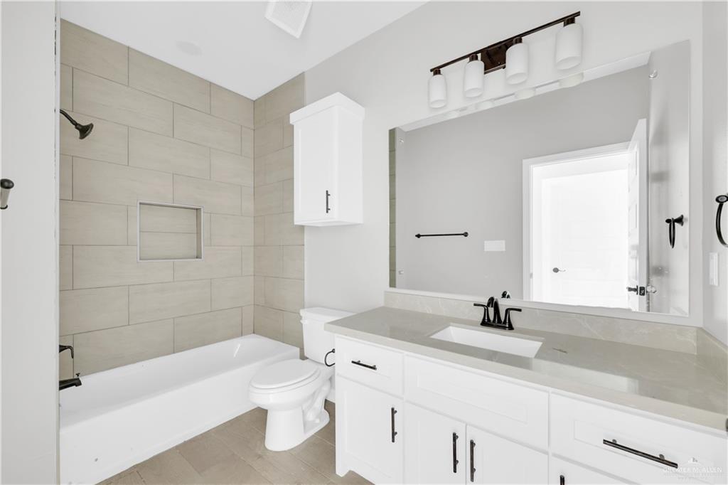 913 West 13th Street, Unit 2 San Juan, TX 78589 - Photo 9 of 14 a bathroom with a bathtub shower sink and toilet