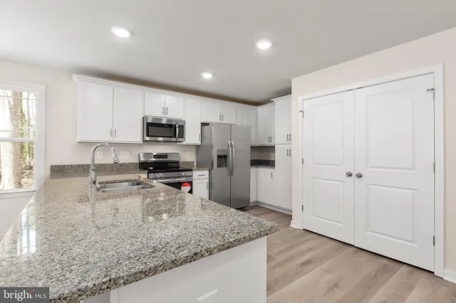 a view of a kitchen with a sink and a window