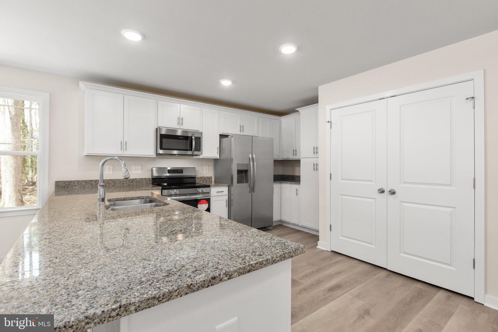 2 Ferry Landing Colonial Beach, VA 22443 - Photo 34 of 62 a kitchen with a refrigerator a stove a microwave and a counter top space