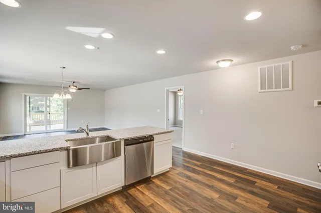 a kitchen with stainless steel appliances granite countertop a sink and a dishwasher