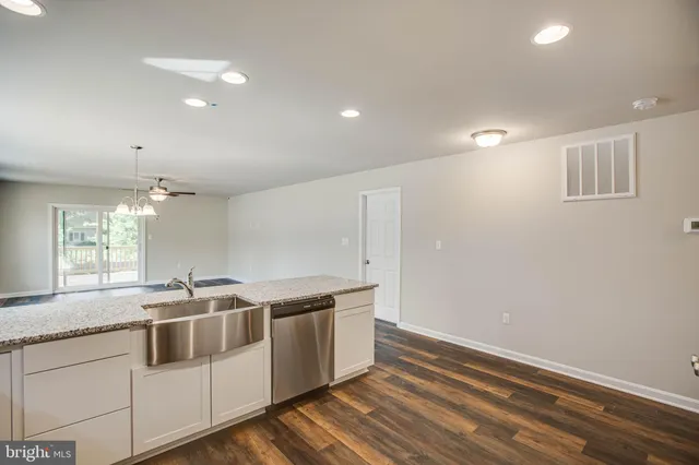 a kitchen with stainless steel appliances granite countertop a sink and a dishwasher