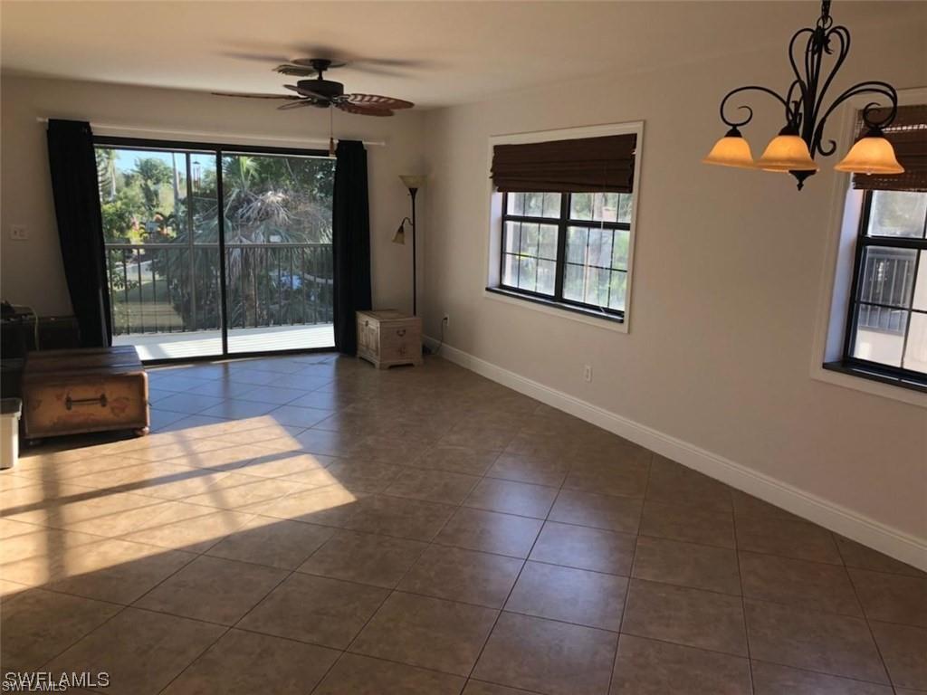 5270 Treetops Drive, Unit J201 Naples, FL 34113 - Photo 4 of 6 Spare room featuring light tile patterned floors and ceiling fan