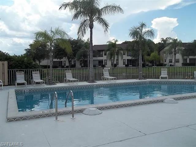 5270 Treetops Drive, Unit J201 Naples, FL 34113 - Photo 5 of 6 Community pool with a patio