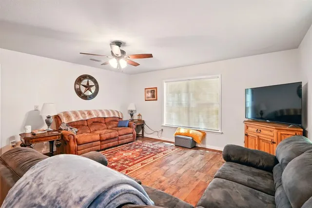 a bedroom with furniture and a flat screen tv